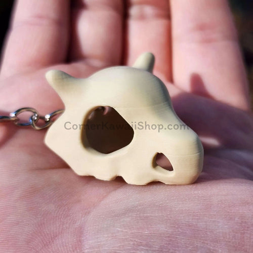 Cubone skull keychain size comparison with hand